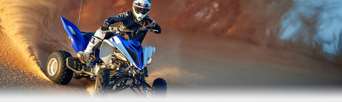 Person riding ATV in sand